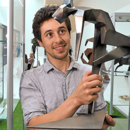 Artist Jacob Chandler with his Commonwealth Games sculpture